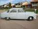 1952 Ford Mainline - This 1952 Ford Mainline sedan is shown in primer gray, parked in a suburban neighborhood.