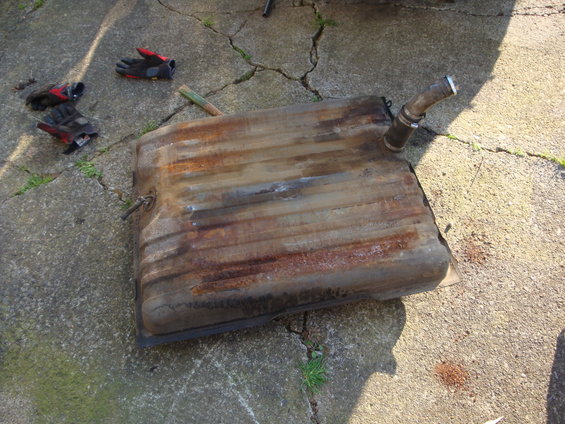 Rusted fuel tank with filler neck on concrete