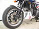 1984 Honda Interceptor - Close-up of a motorcycle's front wheel and suspension system, a custom Captain America decal on the fairing.