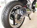 1984 Honda Interceptor - Close-up view of a motorcycle's rear wheel, tire, and exhaust system, with a watermark at the bottom right.