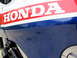 1984 Honda Interceptor - The side panel of a motorcycle displays the HONDA logo with red and white stripes over a blue base.