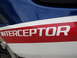 1984 Honda Interceptor - Close-up of a motorcycle's side panel displaying the 'INTERCEPTOR' name in white lettering on a red stripe.