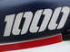 1984 Honda Interceptor - The emblem '1000' is visible on the blue seat of a motorcycle, accented by a red stripe.