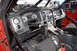 2011 Ford F-150 - The interior of a modified truck features racing seats, a roll cage, and a complex dashboard with multiple gauges and switches.