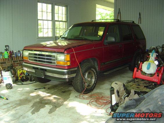 1993 Ford Explorer parked in a garage with tools and other items around it