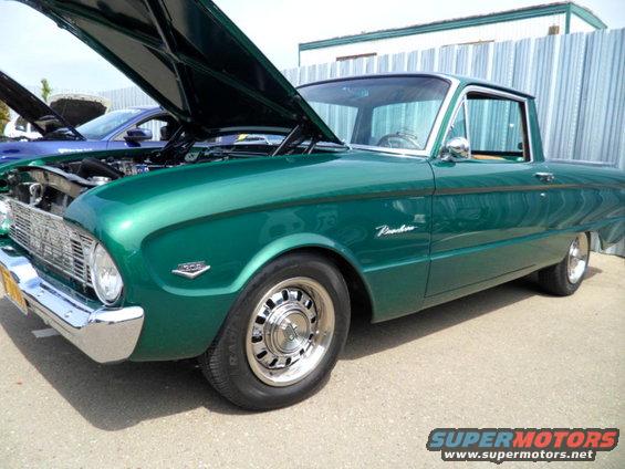 Green pickup truck with hood open, side view, chrome grille and wheels