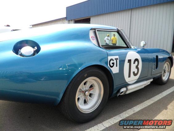 Blue race car with side pipes, number 13, and GT decal
