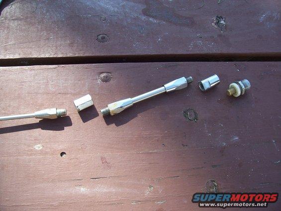 metal rods and connectors laid out on a wooden surface