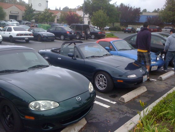 Dark green convertible sports car, front quarter view. 1991 Mazda Miata