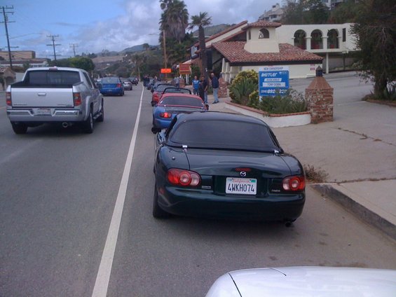Dark green 1991 Mazda Miata rear view with license plate 4WKHO74