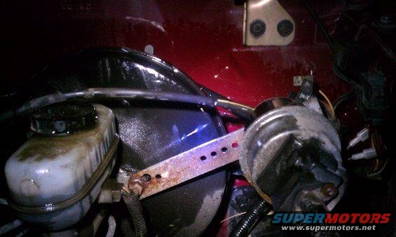 Close-up of brake booster and master cylinder assembly in a vehicle's engine bay