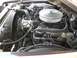 1979 Ford Ranchero - The engine bay of a vehicle, a V8 engine with a chrome air cleaner and various hoses and wires.
