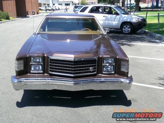 Brown 1977 Ford sedan with chrome grille and quad headlights, parked outdoors