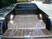 1979 Ford Ranchero - Rear view of a brown 1979 Ford Ranchero pickup truck bed, showing its ribbed floor and tailgate.