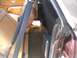 1979 Ford Ranchero - The interior of the vehicle shows tan upholstery, seatbelts, and a carpeted cargo area with aftermarket speakers installed.