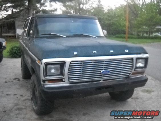 Dark blue Ford truck with chrome grille and "FORD" lettering on hood