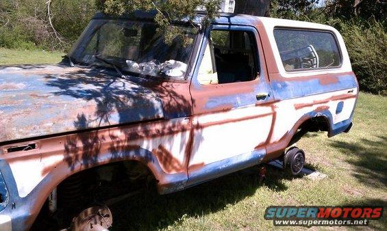 1979 Ford Bronco, rusty blue and white, 3q-front view, on jack stands