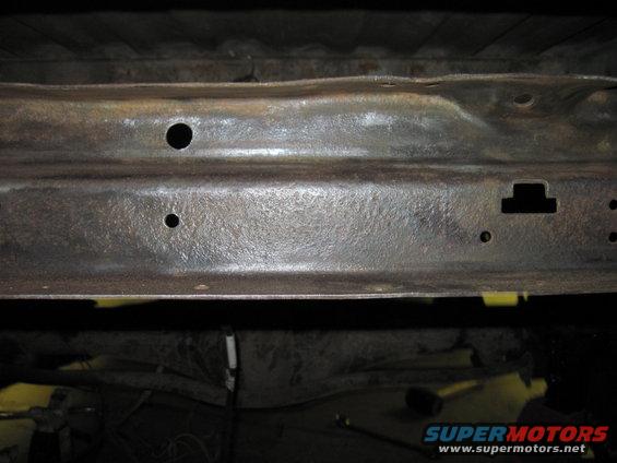Underbody frame with rust and holes, Supermotors.net logo visible