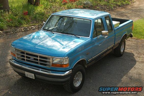 Blue 1992 Ford F-150 pickup truck parked on a gravel driveway