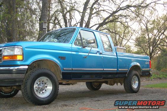 Side view of a blue 1992 Ford F-150 pickup truck with a toolbox