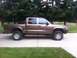2001 Dodge Dakota - Side view of a brown 2001 Dodge Dakota pickup truck with a crew cab.