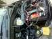 2001 Dodge Dakota - Close-up view of a vehicle's engine bay, focusing on the battery and brake fluid reservoir.