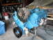 1978 Pontiac Trans Am - A blue engine assembly is shown on a stand, with various components attached, including pulleys and an alternator.