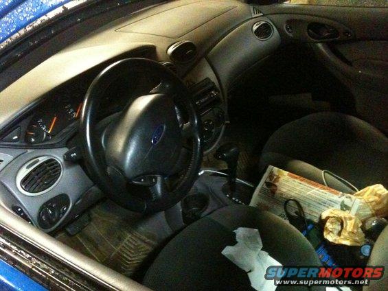 Interior view of a 2002 Ford Focus showing the dashboard, steering wheel, and seats