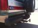 1989 Ford Bronco - Rear view of a green Ford Bronco with a spare tire and tow hitch visible.