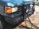 1989 Ford Bronco - Front view of a 1989 Ford Bronco, equipped with a heavy-duty brush guard and auxiliary lights.