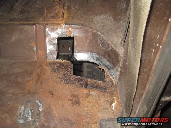 Interior body panel with tire visible through opening