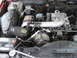 1994 GMC Sierra 3500 - The engine bay of a vehicle, showing various mechanical parts and the air intake system.