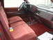 1994 GMC Sierra 3500 - Interior view of a red truck, showing the bench seat, dashboard, and steering wheel.