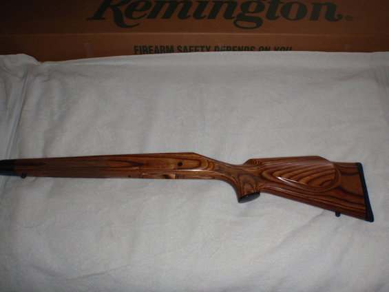 Wooden gun stock with a Remington box in the background