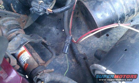 Engine bay wiring harness with black connector and green wire