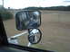 1989 Ford F-250 - View from a truck's side mirror, showing the road and surrounding landscape.