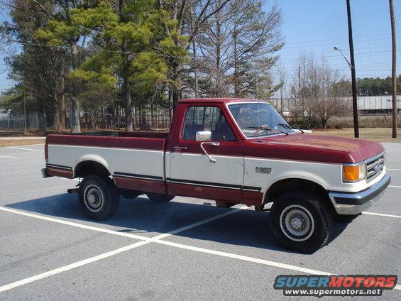 Red and white 1989 Ford F-250 pickup truck, 3/4 front view