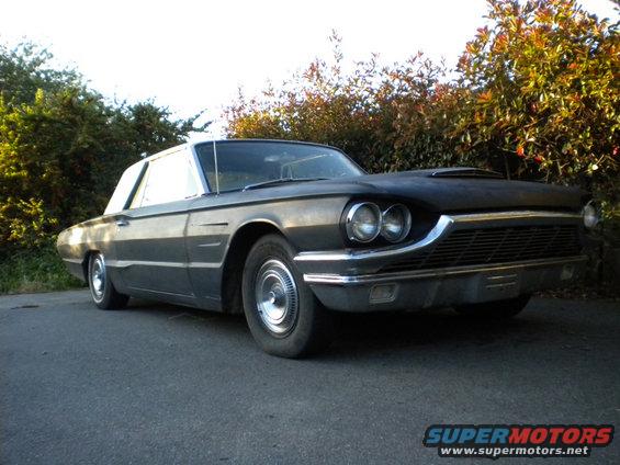 1965 Ford Thunderbird coupe, dark color, parked outdoors