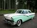1956 Ford Fairlane - A classic 1956 Ford Fairlane sedan in a two-tone white and mint green paint scheme is shown from a 3/4 front angle.