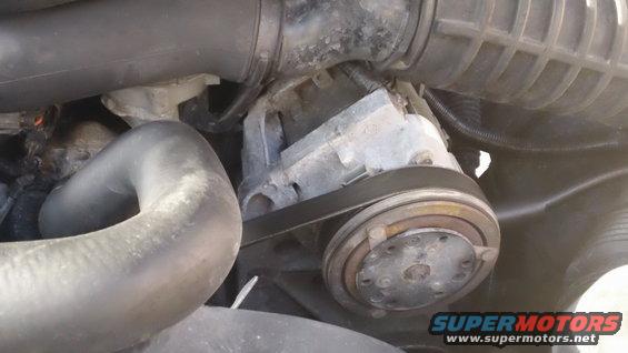 Engine component with belt and pulley, likely part of the cooling system