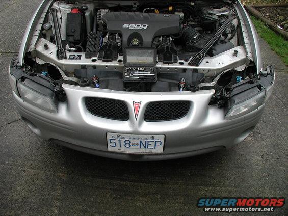 Silver 2002 Pontiac Grand Prix front view, hood open, showing engine and front grille