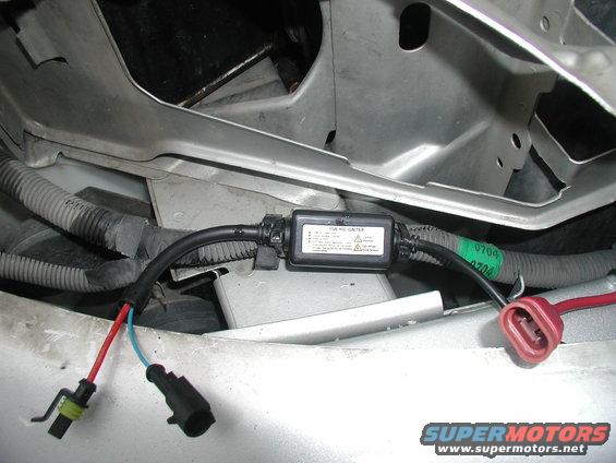 HID igniter box with wiring and connectors, mounted in a vehicle's engine bay