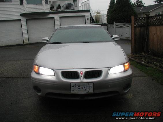Silver 2002 Pontiac Grand Prix front view, headlights on, license plate 518 NEP