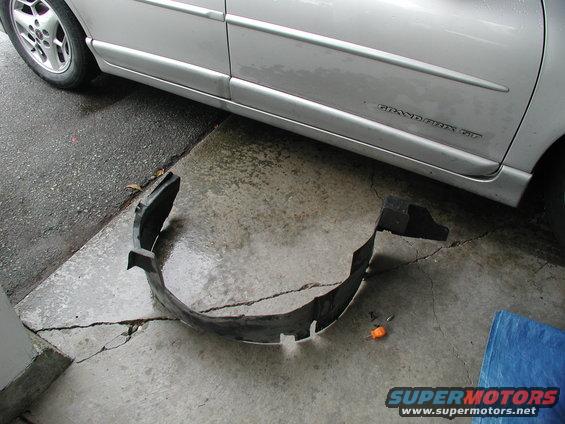 Silver 2002 Pontiac Grand Prix side view with removed fender liner on cracked concrete