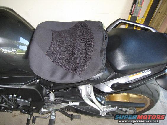 Motorcycle seat with a black mesh cover over the passenger seat section. A key is hanging from the ignition