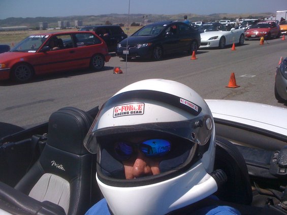 Driver in helmet in a 1991 Mazda Miata, interior view