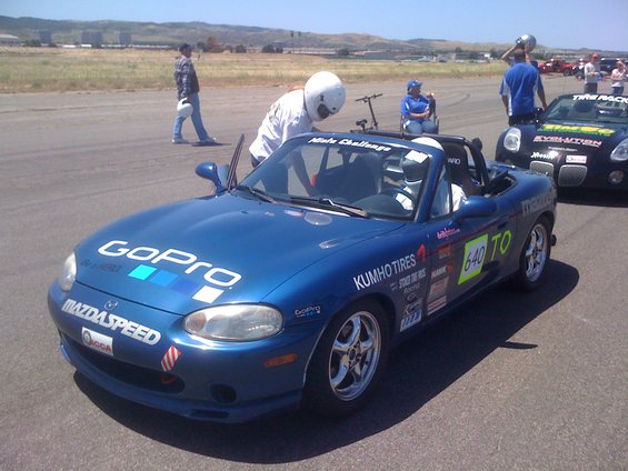 Blue convertible sports car with GoPro decals, racing stickers, and number 640 on the door