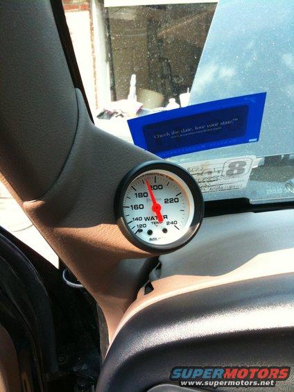 Water temp gauge mounted on the A-pillar inside a vehicle