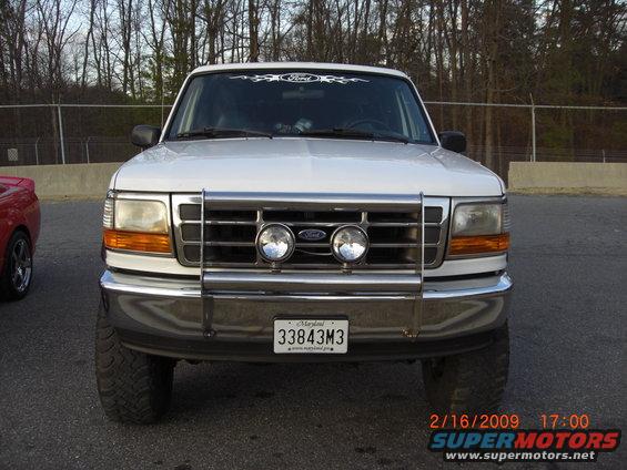 White 1996 Ford Bronco front view with chrome bull bar and fog lights