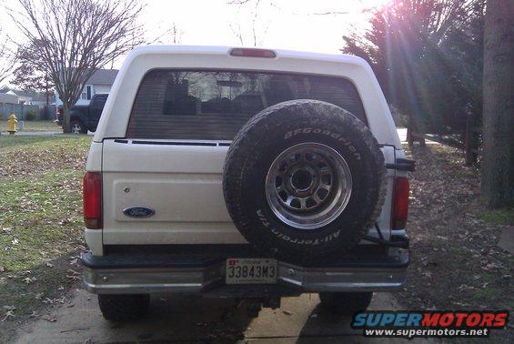 White Ford Bronco rear view, spare tire mounted on back. License plate reads 33843M3